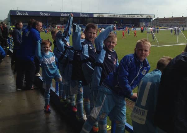 Ballymena United under-10s enjoy the action as they await their next match at the Craigavon Cup.