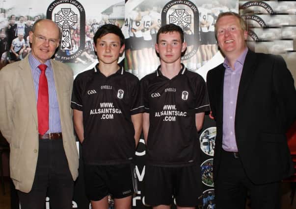 All Saints GAC under-14 players Ryan McGarry (Capt) and Conor Stuart are pictured with Councillor Declan O'Loan who assisted the club with their Civic Grant application. Also pictured is Mr. Eugene Reid who sponsored one of the players.