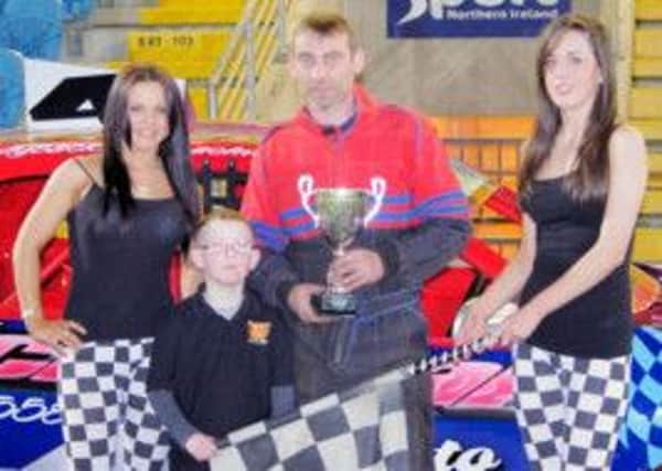 Ballymena's Noel Hazlett collects the Bevan Motorsport Trophy from Raceway mascot Thomas Kirk.