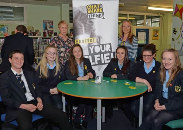 PSNI Sergeant Siobhan Ennis (back left) and Constable Rachael Wison are pictured with Year 12 students from Larne High School at a PSNI internet safety event in the school. INLT 20-002-PSB