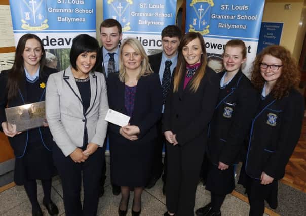 Manager of First Trust Bank Ballymena Jane Mahon (front centre) who visited St Louis Grammar School last week to hand over a cheque for £750 which the the school's student bank had won for finishing second in Northern Ireland in the First Trust Bank Challenge is seen here with Head of Business Studies Mrs McGreevy (left), Niki Duff, First Trust Student Officer and students, L-R, Catriona McDonnell, Kevin O'Kane, Conor Montgomery, Aisling McGarry and Claire Joyce. INBT 17-105JC