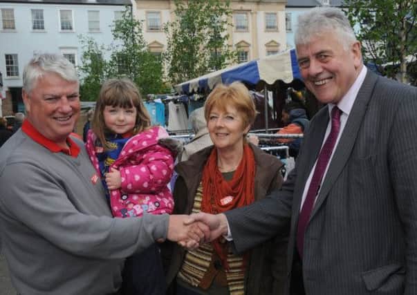 MEP Jim Nicholson meets Sam and Carol Campbell and their granddaughter Lydia on a walkabout in Lisburn on Tuesday 13th May (Market Day).