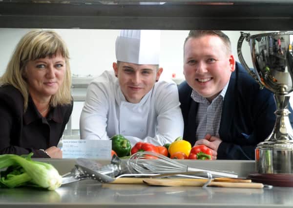 Patryk Sojka is congratulated on winning the Tesco Home Grown Talent Award by Ciaomhie Mannion, Tesco's marketing manager in Northern Ireland, and Thomas Turley, hospitality lecturer at Belfast Metropolitan College. INNT 21-450-CON