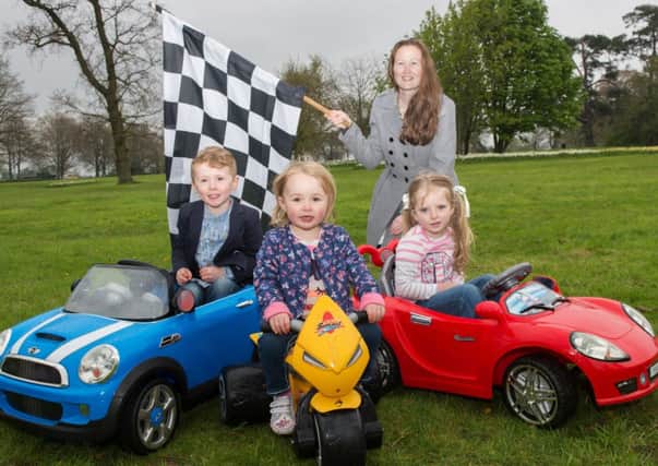 Belfast Motor Show organizer, Kerrie Mann is pictured with Nevin Godfrey (aged 5) from Belfast, Tianna Taggart (2) from Hillsborough and Amelie Stevenson (4) from Holyood.