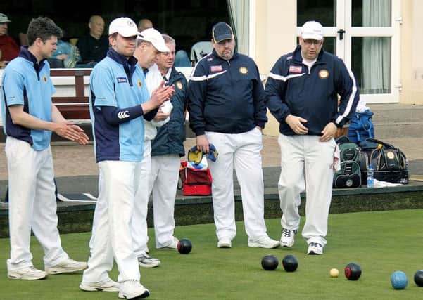 Ballymena Bowling Club team members applaud a great delivery from a team mate. INBT 21-815H