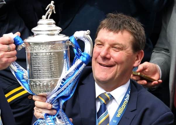 St Johnstone manager Tommy Wright holds the Scottish Cup onboard the parade bus as it makes its way through the streets of Perth  during the Scottish Cup winners parade in Perth. Photo credit: Andrew Milligan/PA Wire