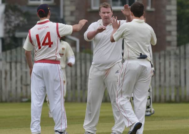 Brigade's Richard Hepburn is congratulated by his team-mates after he had taken an early Eglinton wicket on Saturday. INLS2014-117KM
