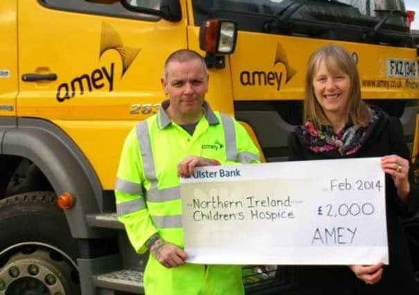 Stephen Houston of AMEY presents a cheque to Ellen Hillen of NI Childrens Hospice.