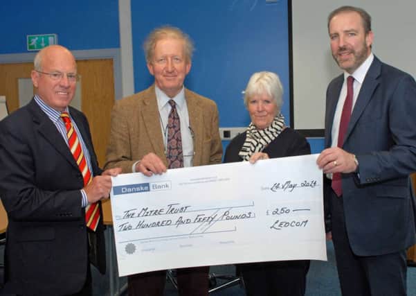 Ken Nelson (right), CEO of Ledcom, and Henry Fletcher (left), director of Ledcom, present a cheque for £250 to Prof James Nixon, chair of the Mitre Trust at Musgrave Park Hospital, and Pam Anstey, Mitre coordinator. The money was raised by contributions from Ledcom staff. INLT 21-007-PSB