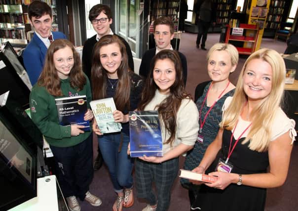 Local students try the new book scanner at Coleraine Library with librarians Maxine Hasson and Kirsten Walker. INCR21-355PL