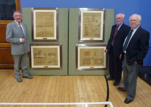 Ffrom left)  Dr Robert McMillen receiving the restored vellum architect's drawings from Howard and Hugh Taggart. INNT 21-471-CON