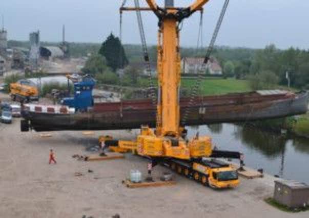 Lifting the huge barge.