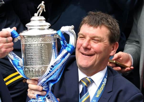 St Johnstone manager Tommy Wright holds the Scottish Cup onboard the parade bus as it makes its way through the streets of Perth  during the Scottish Cup winners parade in Perth. PRESS ASSOCIATION Photo. Picture date: Sunday May 18, 2014. See PA story SOCCER St Johnstonel. Photo credit should read: Andrew Milligan/PA Wire