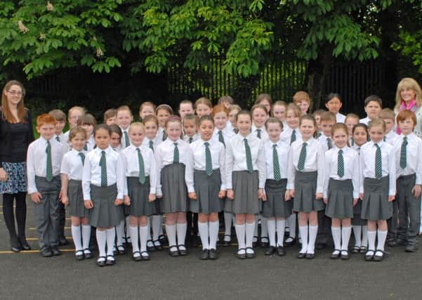 Miss Hill and Mrs Moore are pictured with the Oakfield Primary School choir who picked up the`Lowry Trophy` at Carrickfergus Musical Festival. INCT 22-001-PSB