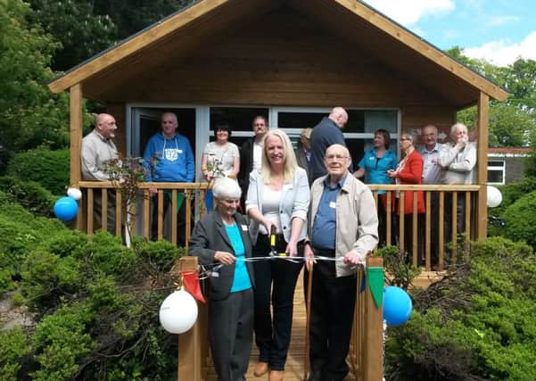 Tommy Foster (who has dementia), Dawn Beckett (from the Alzheimer's Society) & Theresa Clarke (who has dementia). With a mixture of Alzheimer's Society staff, volunteers, members of the Men's Friendship group, people with dementia and representatives of the Northern Trust.