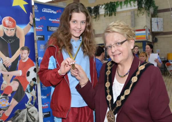 The Mayor of Lisburn presents Leah Bethel with her gold medal which she won in the Girls 11 Year Old 25m Backstroke. Leah set a new record time of 16.20s.