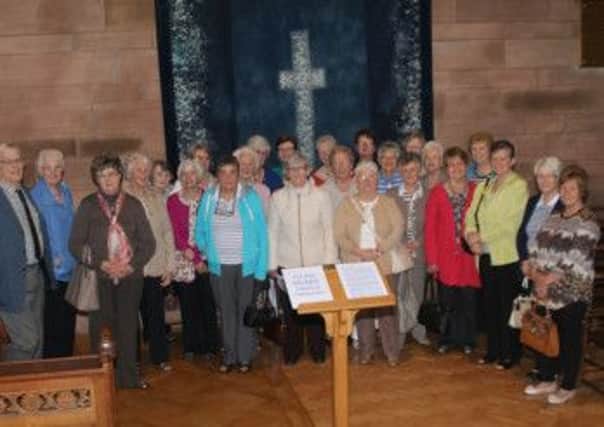 Cathedral guide Vernon Clegg is with the other group from Ballyloughan Ladies Circle in front of the handcrafted Titanic Pall  INBT-21F-
BALLYLOUGHAN LADIES.