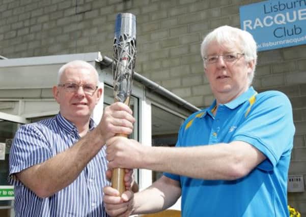 Trevor Woods, Lisburn Racquets Club, and Robert McVeigh, chairman of the Northern Ireland Commonwealth Games Committee, pictured with the Queen's Baton as it arrives in Lisburn. US1422-503cd Picture: Cliff Donaldson