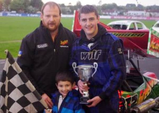 F2 final winner Christopher Kincaid collects his trophy from meeting sponsor Derek Fullerton and 5 year old Lucas Bayram.