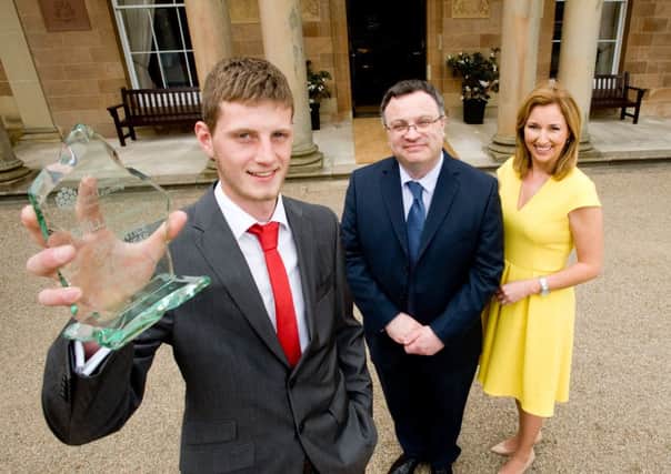 Michael Surgenor, an apprentice in bricklaying, from Ballyclare, has been celebrated as a finalist in the Apprentice of the Year 2014 awards. Michael is pictured at an awards ceremony held in Hillsborough Castle with Employment and Learning Minister Dr Stephen Farry and presenter Claire McCollum. INNT 22-456-CON