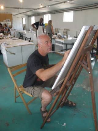 Tommy Barr painting at his easel