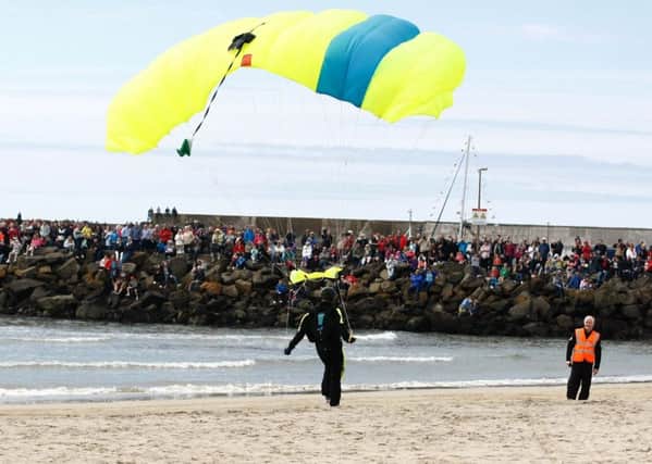 This skydiver lands safetly on the beach. INCR22-163KMA
