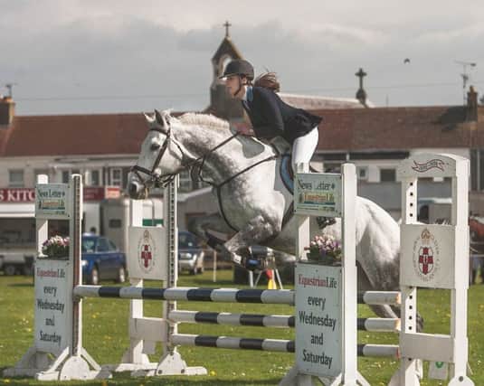 Harriet Bell and Georgie jump the 0.90m spread poles to go double clear.
