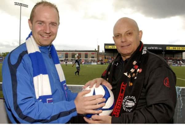 ITS MINE.....Moneyslane First Team Captain, Gareth Bingham, tussles with former Manchester United mid-field player Ray Wilkins, who will be one of a host of galaxy Manchester United Legend players, who will play Moneyslane Football Club Select, during a exhibition match at the Grand Opening of the new club complex at Jubilee Park, Moneyslane, on the 2nd August 2014.  © Photo: Gary Gardiner.