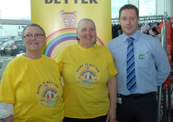 After, local Asda employee Christine Archer (centre) with completed head shave by Chris Davies (left) and Asda General Store Manager Simon Fisher, Christine had her head shaved to raise funds for the Womens Aid charity. INLT 20-022-PSB