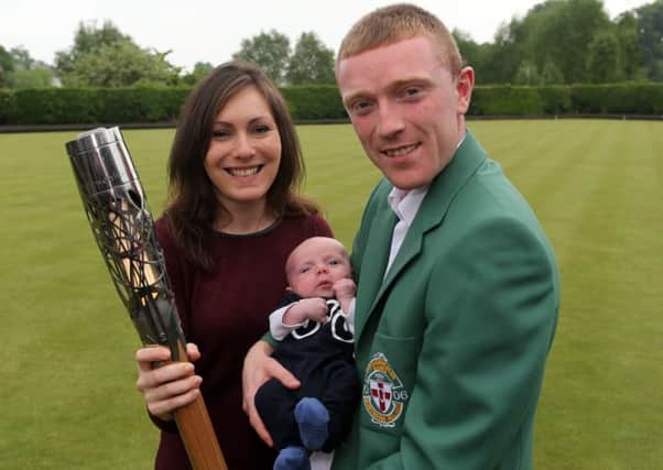 Northern Ireland cycling team manger Ryan Connor, his wife Julie and five-week-old son Ethan with the Commonwealth Games Queen's Baton at Ballymena Bowling Club. INBT 22-172CS