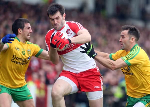 ©/Lorcan Doherty Photography - 25th  May 2014.

Ulster GAA Senior Football Championship. Derry V Donegal.

Derry's Mark Lynch and Donegal's Paddy McGrath and Karl Lacey.

Photo Lorcan Doherty Photography