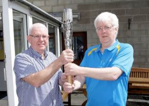 Trevor Woods, Lisburn Racquets Club, and Robert McVeigh, chairman of the Northern Ireland Commonwealth Games Committee, pictured with the Queen's Baton as it arrives in Lisburn. US1422-502cd Picture: Cliff Donaldson
