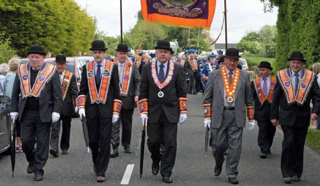 STEPPING OUT. Leading dignitaries head the parade at the opening ceremony of Lisnagaver Orange Hall on Saturday.INBM22-14 055SC.