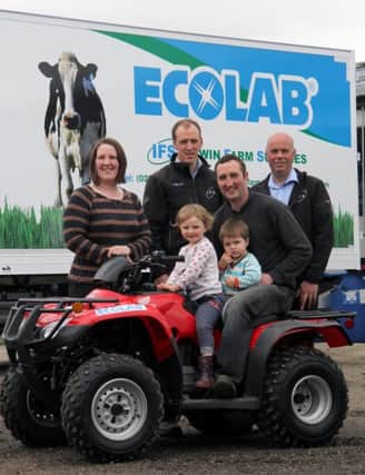 Winners of the Honda Fourtrax 250ES quad on the Ecolab stand at Balmoral Show were the Hanna family, John, Jane, Rachel (3) and Michael (21mths) from Ballymoney. They took delivery of their prize from Irwin Farm Supplies/Ecolab dairy hygiene specialists Nathan McKendry and Maurice Wylie. Picture: Julie Hazelton