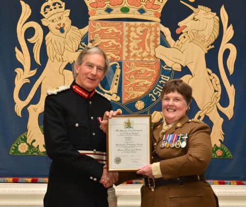 Major Green receiving the Lord Lieutenants Certificate for Outstanding Meritorious Service Above and Beyond The Call of Duty from Colonel David Lindsay, Her Majestys Lord Lieutenant for the County of Down.