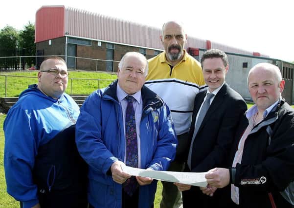 Colin Graham and Jim McIlroy of Harryville Partnership,  Martin Clarke, Paul Frew, DUP MLA; and new Councillor Reuben Glover look over the plans for replacement of Harryville Community Centre.