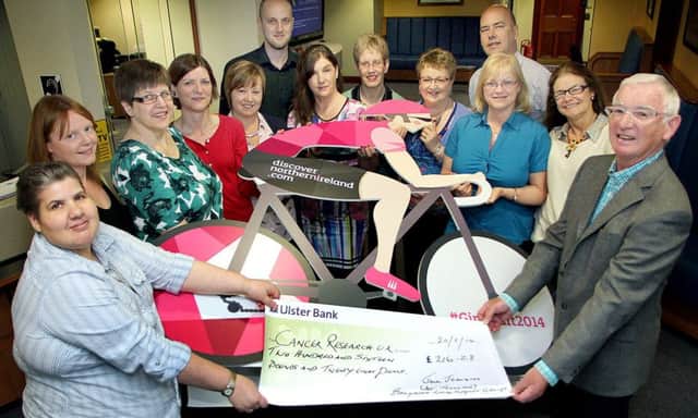 Staff of Ballymena Borough Council photographed last week in Ardeevin where they presented a £211-28 cheque to Jackie Johnston, Cancer Research; proceeds of their "Giro Wear Pink Day". INBT 23-817H