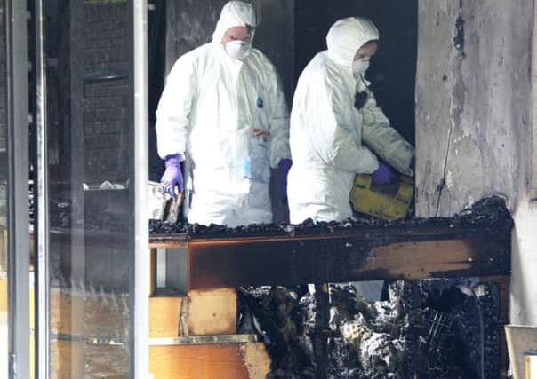A PSNI forensics team surveys the damage to the reception area of the Everglades Hotel in May.