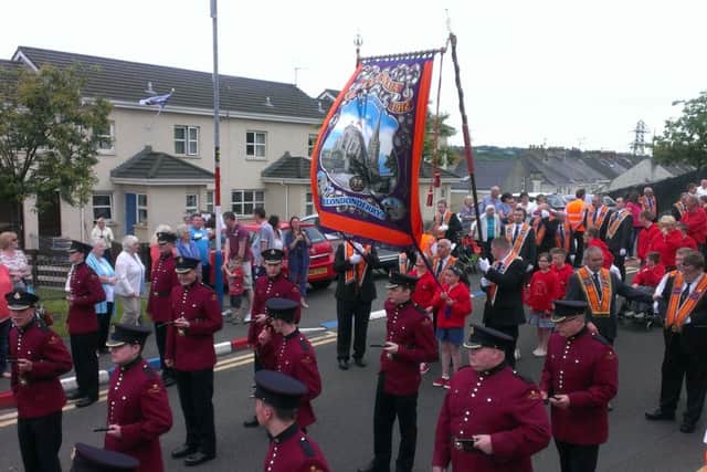 Brethren of Britannia LOL 1912 and their guests, led by William King Memorial Flute Band, parade their new banner.