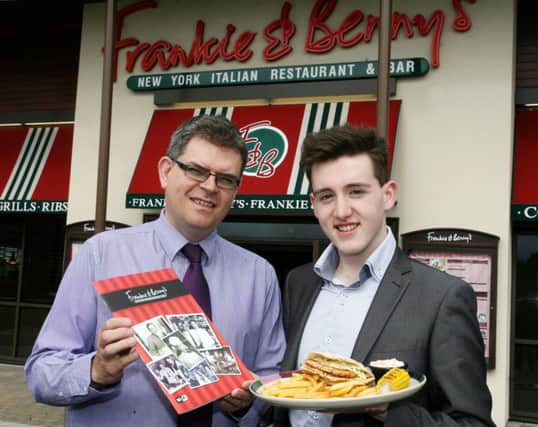 James Meredith (Restaurant Manager) and Jonathon Murray (area marketing co-ordinator) with the new menu at Frankie & Benny's. INBT23-255AC