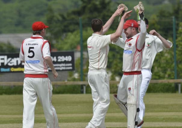 The Strabane second's players celebrate after taking an early wicket during Saturday's match against Bready 2nd's. INLS2214-120KM