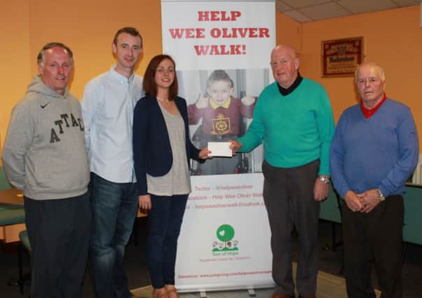 Jimmy Alexander, Sammy McNeil and William McConaghie, who were referees in the LMA League, donated part of their refereeing money to Help Wee Oliver Walk. Charlene and Neil Dickey, Olivers parents, received the donation on behalf of their son. Also, a thank you must go to Tommy Docherty who came up with this idea.