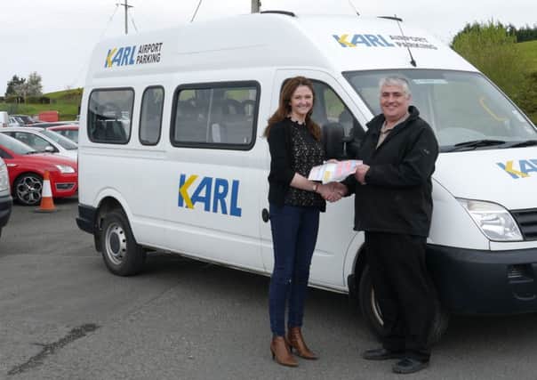 Gayle Boyce of KARL Airport transport presenting Davy Boyd, treasurer of Carniny A&YFC with a set of keys for a personnel carrier to be used by the club.