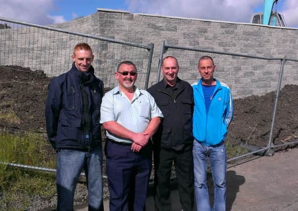 Eddie Bell (left) and Robert McDowell (right) of Ballyduff Community Redevelopment Group with Cllr Robert Hill and PUP representative Jackie Shaw in front of the estate's new 'entrance feature'. INNT 23-512CON
