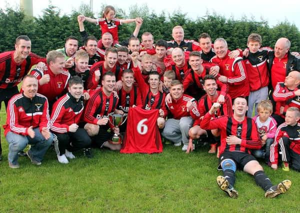 Harryville Homers celebrate after winning the Rainey Cup on Friday night - the SIXTH trophy that Robert Duddy's side have won in an incredible season. See page 45 for more coverage. INBT 23-850H