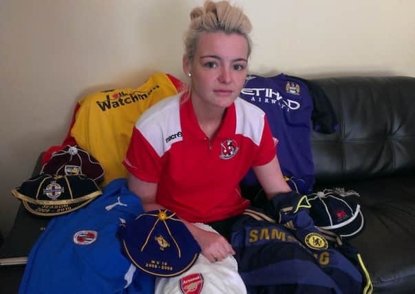 Footballer Trudi Harbinson with the kits of the teams she's played for during her careers and some of the Northern Ireland caps she's won.
