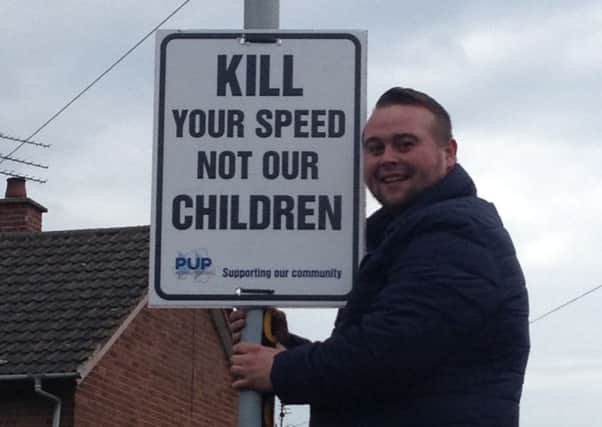 PUP member Aaron Dowey erects one of the PUP's new signs.