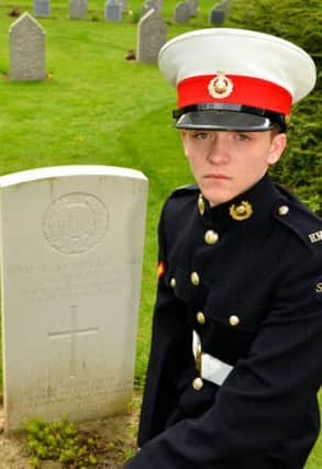 Marine Cadet Lance Corporal Nathan Jermy from Carrickfergus visits the grave of a fallen Royal Marine Light Infantry soldier. INCT 24-703-CON