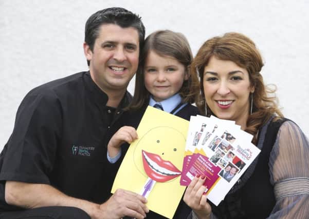 Philip McLorinan, Principal Dentist and owner of Dunmurry Dental Practice (left) with Adrianna Paxton from Stepping Stones NI (right) and Maria McLorinan from St Josephs Primary School, Lisburn at the launch of the Kids Oral Health Challenge, which the practice is running with the local charity during National Smile Month.