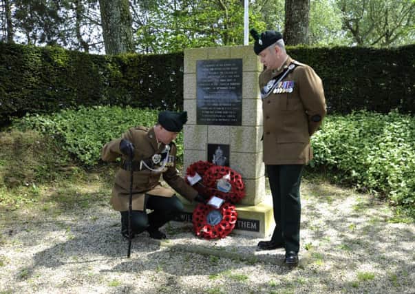 Lieutenant Colonel Owen Lyttle and RSM Darren Clarke, of 2 Royal Irish  laying a wreath at the 2 RUR memorial at Cambes.